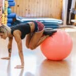 Woman Doing Pilates Exercises with a Ball